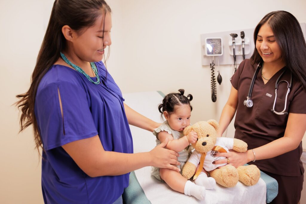 NATIVE HEALTH nurse and a mother with her baby during a pediatric visit